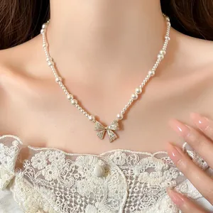 Exquisite French style pearl necklace featuring a detailed zircon bow pendant on model