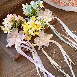 Detailed close-up of romantic floral hair clips with colorful ribbons and beads