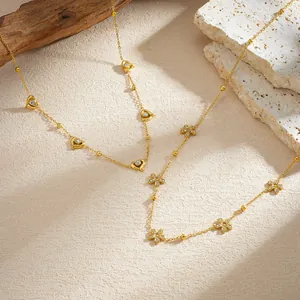 Detailed view of gold-plated stainless steel necklaces with heart and flower crystal charms