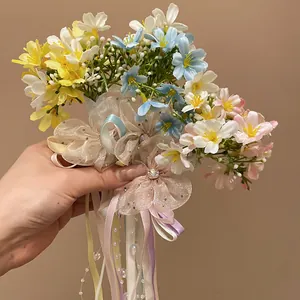 Close-up of colorful spring flower hair clip with ribbons and pearls decoration detail