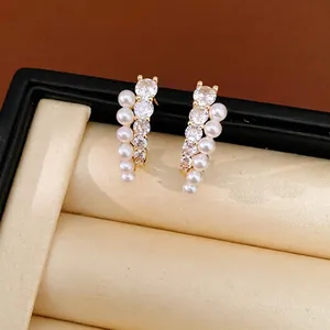Elegant gold-plated silver needle earrings with shimmering cubic zirconia and white pearls