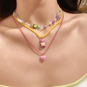 Layered necklace set with butterfly, gummy bear and heart charms in vibrant candy colors