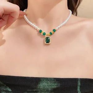 Elegant vintage style pearl beaded necklace featuring an emerald green square pendant.