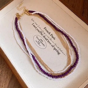 Detail shot of a vintage multi-layer necklace with pearls and purple crystal beads