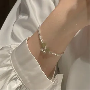 Minimalist silver bamboo joint bell bracelet featuring green stone beads for women