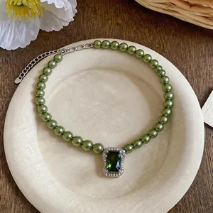 Elegant olive green pearl necklace with a vintage square green zircon pendant detail.