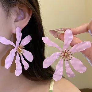 Elegant oversized pink flower earrings with golden stamens for a sweet vacation style