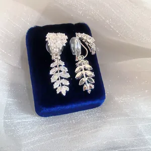 Detailed close-up of elegant leaf-shaped clip-on earrings with marquise-cut zircons