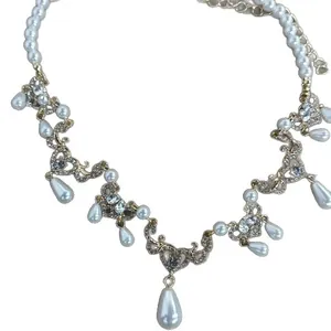 Vintage court style pearl necklace with sparkly rhinestone accents and teardrop pendants
