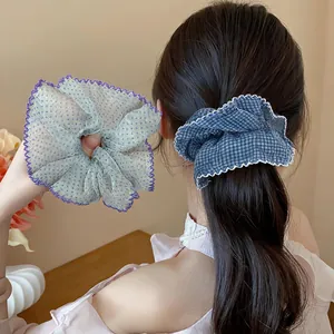 Detail of chiffon polka dot and checkered hair scrunchies with delicate lace edges