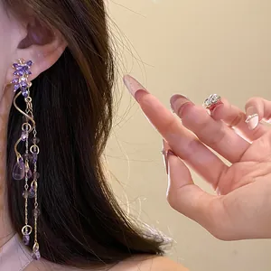 Close-up of elegant purple crystal butterfly tassel earrings with waterdrop beads
