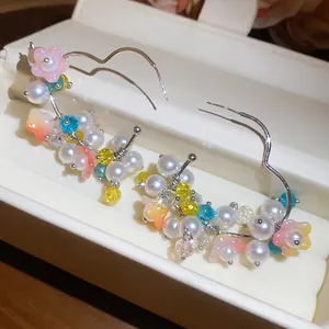Handmade colorful pearl flower hoop earrings displayed in an elegant white jewelry box