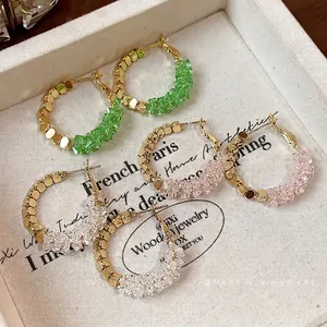 Set of three pairs of 14K gold plated crystal hoop earrings with faceted gold beads