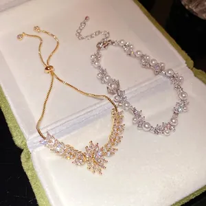 Exquisite zircon wheat flower adjustable bracelet and pearl hand chain set in box.
