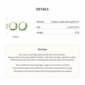Detail view of 14K gold-plated crystal hoop earrings with 925 silver needle specs