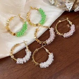 Detailed view of 14K gold-plated hoop earrings with green, pink, and clear crystal beads