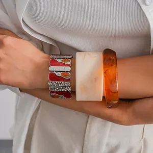 Close-up of metal dripping oil square bracelet and marble resin geometric bangles