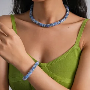Elegant blue and translucent crystal beaded necklace and bracelet set worn by a model