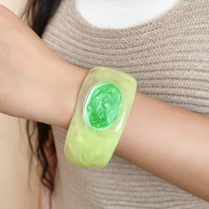 Detailed view of a green resin bracelet with unique dripping oil texture on a model