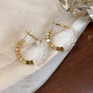 Close-up detail of luxury 14K gold plated hoop earrings with shimmering crystal beads