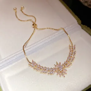 Detailed view of elegant gold zircon bracelet with sparkling wheat ear and floral design
