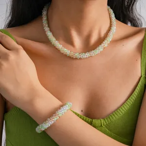 Detailed view of the elegant crystal beaded necklace and bracelet set worn by a model