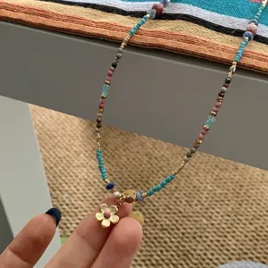 Retro ethnic style stainless steel beaded necklace with a delicate golden flower pendant