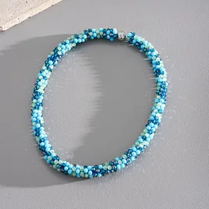 Intricate blue crystal beaded necklace detail featuring a secure silver magnetic clasp.