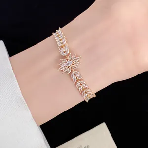 Detailed macro view of gold zirconia bracelet with marquise-cut wheat flower stones.