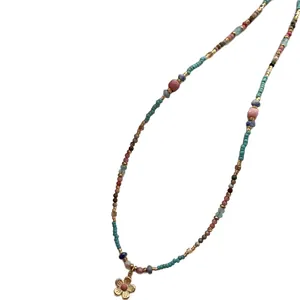 Vintage ethnic style beaded necklace with golden flower pendant and colorful stones