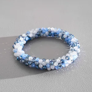 Macro view showing the intricate detail of blue and white braided crystal beads and shine