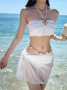 Detail view of bohemian gold waist chain with shells and pearls for beach wear