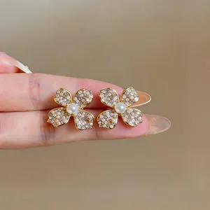 High-quality close-up of elegant flower stud earrings with zirconia petals and pearl