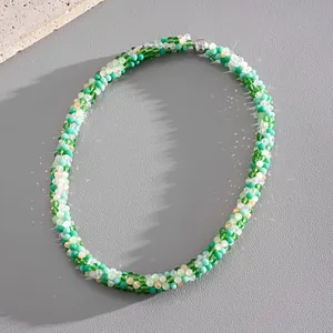 Detailed view of fresh green and white crystal beaded necklace with silver magnetic clasp