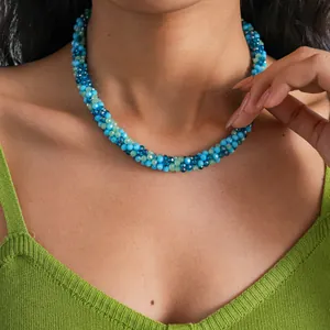 Detailed view of elegant blue and green crystal beaded choker necklace worn by a model