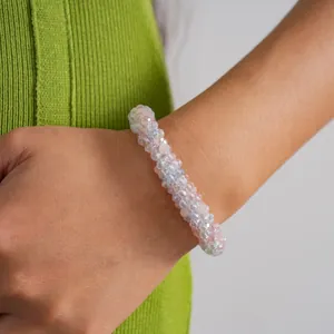 Detail view of iridescent and pink faceted crystal beaded bracelet worn on wrist