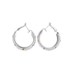 Silver round hoop earrings with colorful polka dots in a minimalist modern style