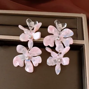 Elegant pink acrylic floral drop earrings featuring clear heart studs and crystals