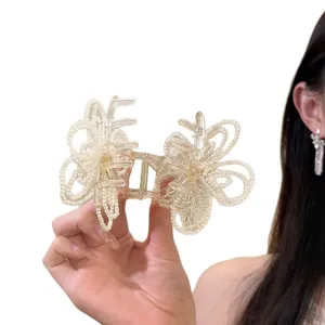 Elegant Korean pearl butterfly hair claw clip for bun hairstyles on white background