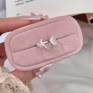 Silver shell and starfish open ring beautifully displayed in a pink velvet jewelry box