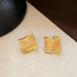Elegant vintage gold square stud earrings featuring a unique irregular textured hammered finish
