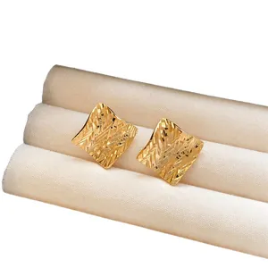 Elegant gold square stud earrings with a textured geometric design for a retro look