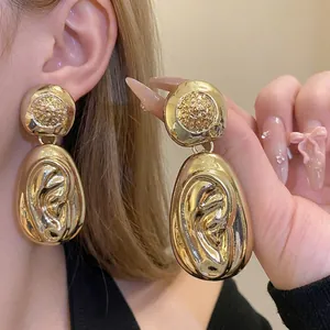 Exquisite gold statement drop earrings with hammered texture for elegant fashion