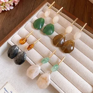 Elegant resin geometric drop earrings in multiple colors displayed on a wooden jewelry tray