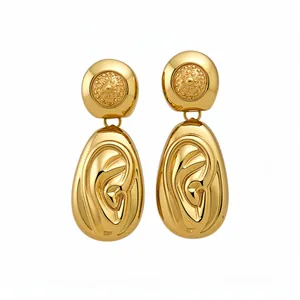 Elegant gold drop earrings with textured circular studs and ear-shaped pendants