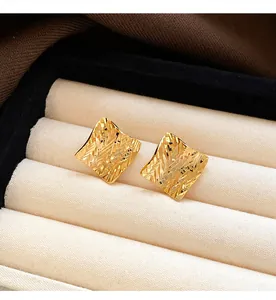 Macro detail showing the unique textured gold finish of these square vintage stud earrings.