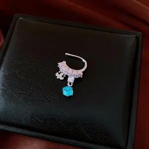 Sparkling cubic zirconia non-pierced ear cuff with a blue crystal cube pendant for women.