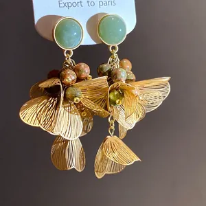 Elegant gold floral drop earrings with green aventurine stones and colorful stone beads.