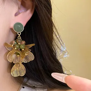 Elegant flower petal drop earrings with colored stones and golden wire mesh tassel design