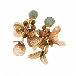 Elegant gold floral petal stud earrings with natural stone tassel design on white back